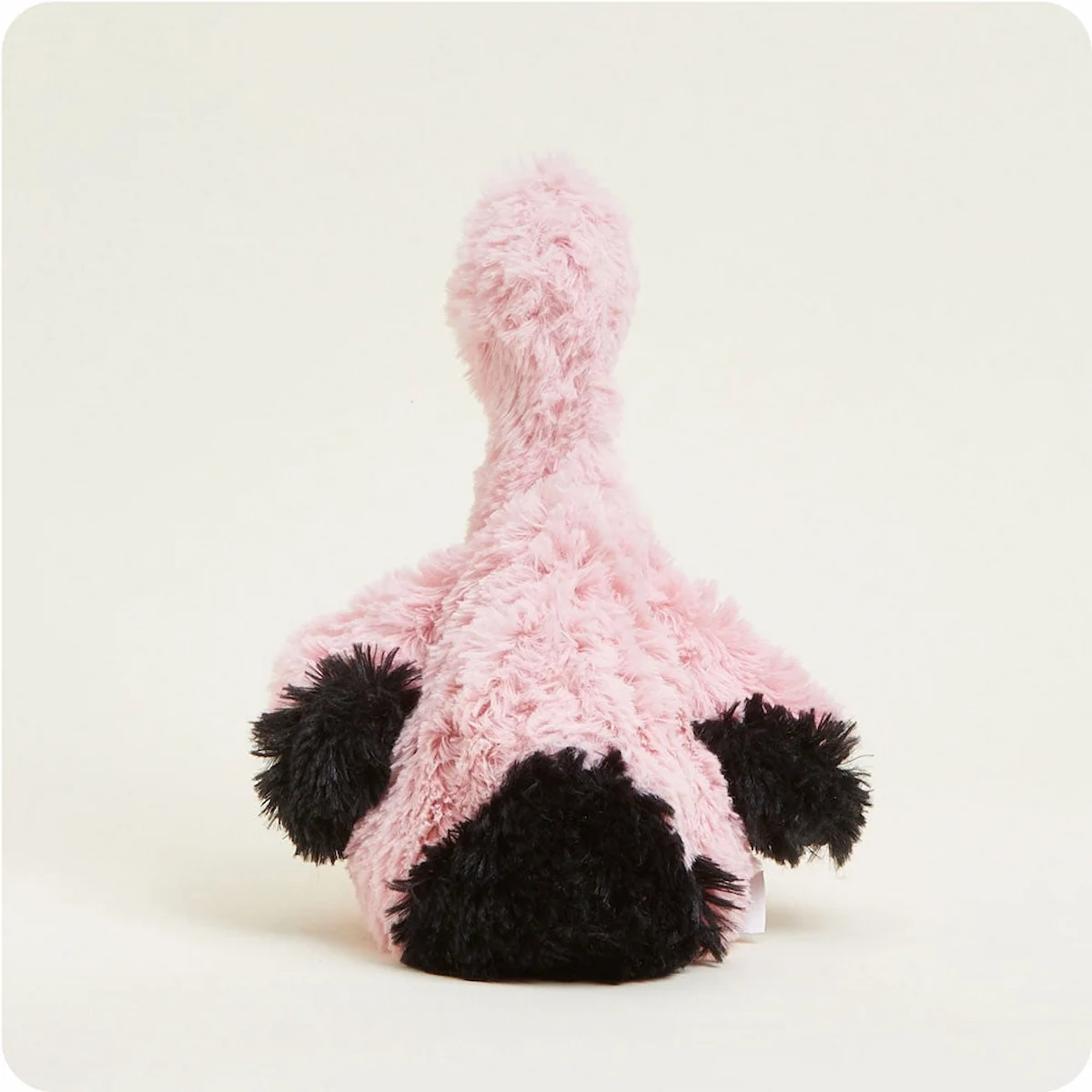 Back view of a Warmies pink flamingo plush stuffed animal sitting down.